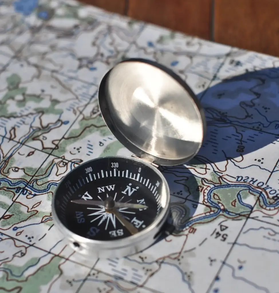 Metallic nautical compass on navigation chart representing European market entry strategy and expansion.
